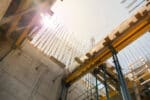 Rising construction costs in 2025: A view of reinforced concrete and steel framework at an active construction site, highlighting cost management challenges and policy shifts in the industry.