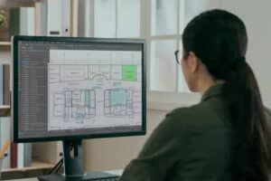 A professional using Bluebeam Revu software to scale markups on a digital construction blueprint, ensuring precise measurements and streamlined collaboration.