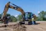 Excavator and construction worker on a job site in Pittsburgh, supporting PIT2Work's efforts to close the skilled labor gap in the construction industry.