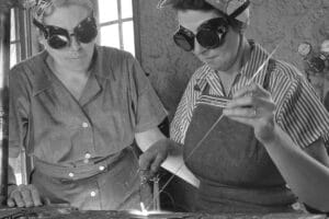 Two women welders in protective goggles work together during World War II, showcasing the vital role women played in construction and industrial labor. A powerful reminder of their contributions in breaking barriers and transforming the workforce.