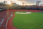 Fenway Park at sunset, showcasing the iconic Green Monster and empty grandstands—one of Major League Baseball’s most historic stadiums.