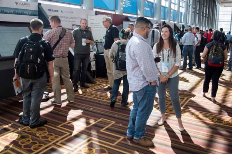 Construction professionals networking and exploring tech exhibits at a bustling industry conference—highlighting the dynamic energy of Bluebeam Unbound, happening in Washington, D.C., Sept. 30–Oct. 2, 2025. Register now to connect, learn, and lead the future of AEC.