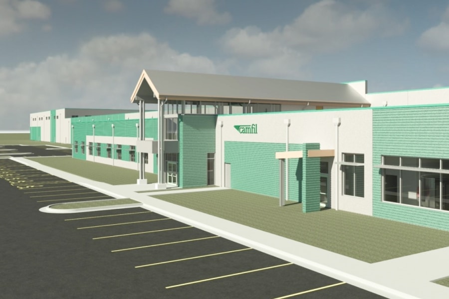 Architectural rendering of Camfil’s new flagship air filtration manufacturing facility in Texas, showcasing resilient design features, modern facade, and expanded parking space under a partly cloudy sky.