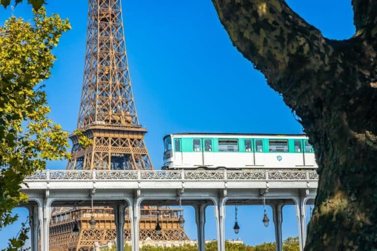 Paris Métro train crossing near the Eiffel Tower, showcasing historic infrastructure and urban transit innovation in the heart of Paris