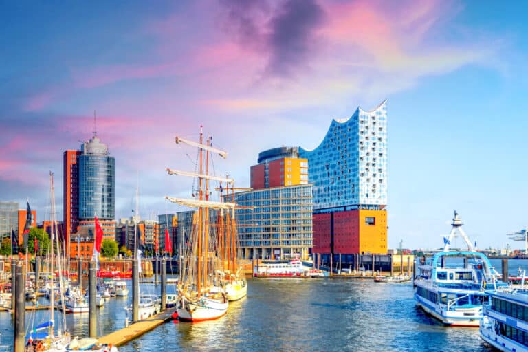 Modern harbor view in Hamburg, Germany featuring the iconic Elbphilharmonie concert hall and ships, symbolizing innovation and architecture—ideal for an article on Germany’s leadership in prefabricated construction.