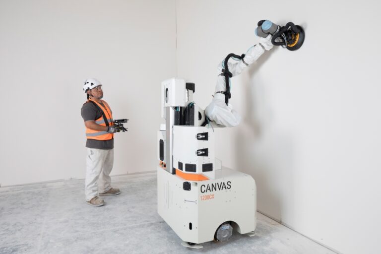Construction worker operates the Canvas 1200CX drywall robot, which autonomously tapes, muds, and sands a wall surface without blueprints or scans, streamlining interior finishing work on a modern jobsite.
