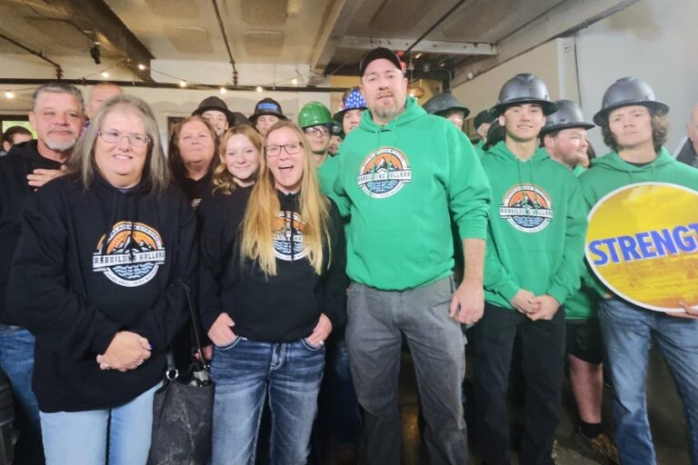 Rebuilding Hollers volunteers in hoodies and hard hats gather after Hurricane Helene to support rebuilding efforts in western North Carolina.