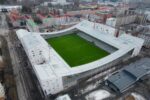 Aerial view of Finland’s Tammela Stadium in Tampere, a mixed-use urban design project by JKMM Architects that integrates a modern football pitch with residential apartments, retail spaces, and public amenities, showing how stadiums can revitalize neighborhoods instead of isolating them.