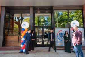 Hire360 leaders, contractors and partners gather outside the Chicago nonprofit’s training center, highlighting workforce development and support for small construction businesses.