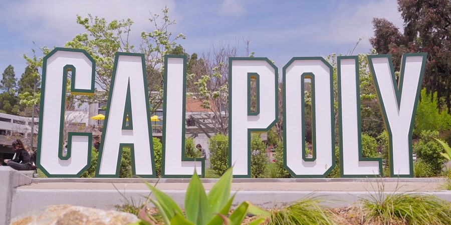 Large CAL POLY campus sign surrounded by greenery and blue sky, representing Cal Poly’s construction management program that embeds Bluebeam software into the curriculum to prepare students for digital workflows.