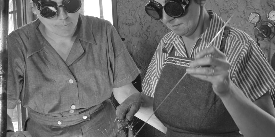 Two women welders in protective goggles work together during World War II, showcasing the vital role women played in construction and industrial labor. A powerful reminder of their contributions in breaking barriers and transforming the workforce.