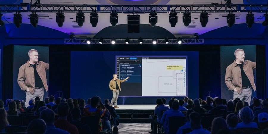 Bluebeam’s Luke Prescott presents new product innovations during the Unbound 2025 conference in Washington, D.C., showcasing workflow updates on stage before a full audience.