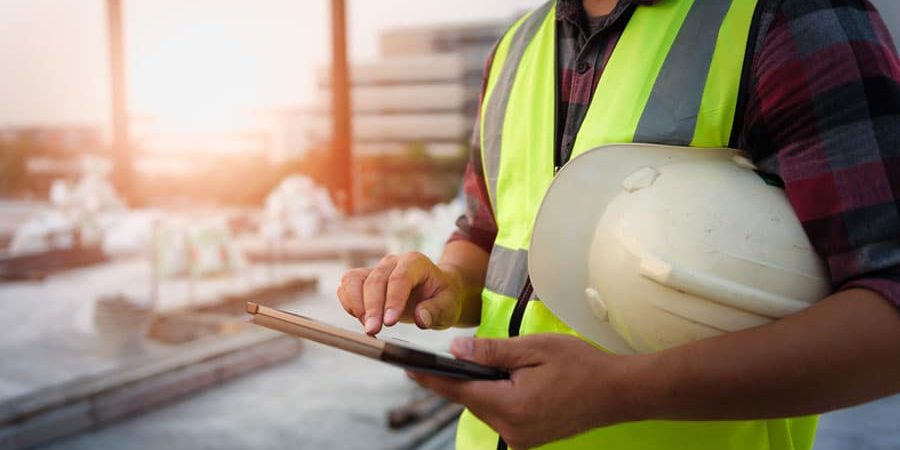 construction man looking at ipad golder