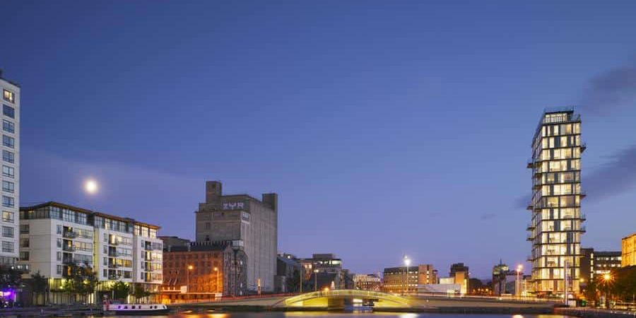 Evening view of Dublin’s Grand Canal Dock featuring iconic modern and historic architecture, including Boland’s Quay and the ZUR building, illustrating the city’s evolving skyline—featured in “7 Buildings That Tell the Story of Dublin’s Architecture.