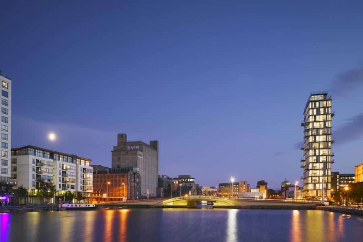 Evening view of Dublin’s Grand Canal Dock featuring iconic modern and historic architecture, including Boland’s Quay and the ZUR building, illustrating the city’s evolving skyline—featured in “7 Buildings That Tell the Story of Dublin’s Architecture.