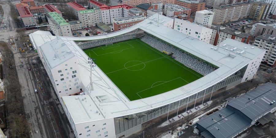 Aerial view of Finland’s Tammela Stadium in Tampere, a mixed-use urban design project by JKMM Architects that integrates a modern football pitch with residential apartments, retail spaces, and public amenities, showing how stadiums can revitalize neighborhoods instead of isolating them.